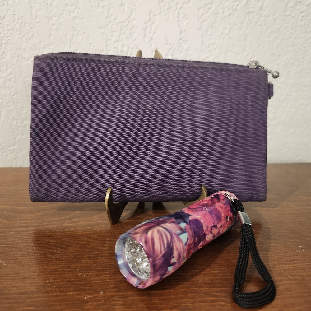Floral Colored Mini Flashlight accompanying Purple Zip Storage Bag.